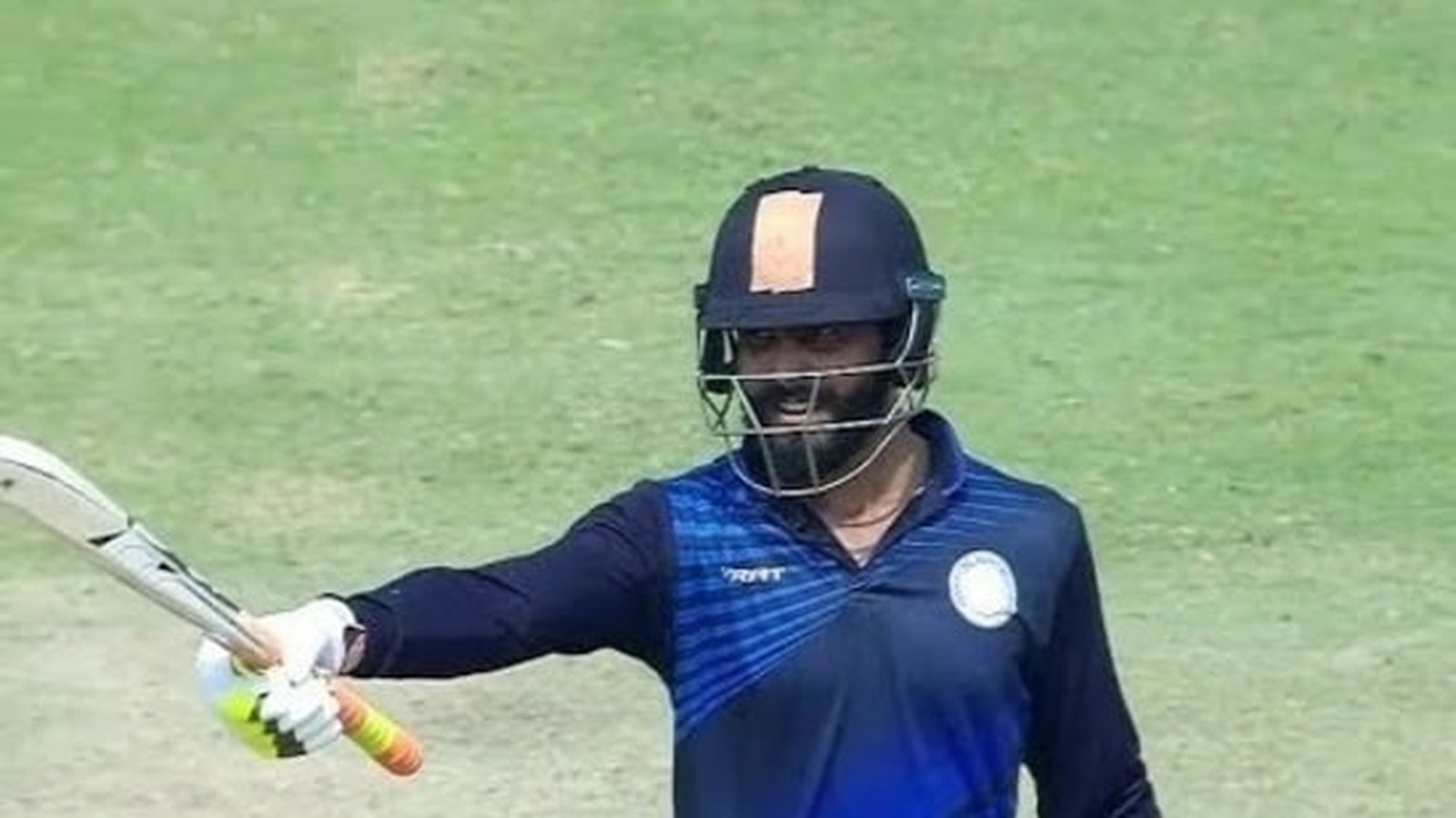 Cricketer batting on field