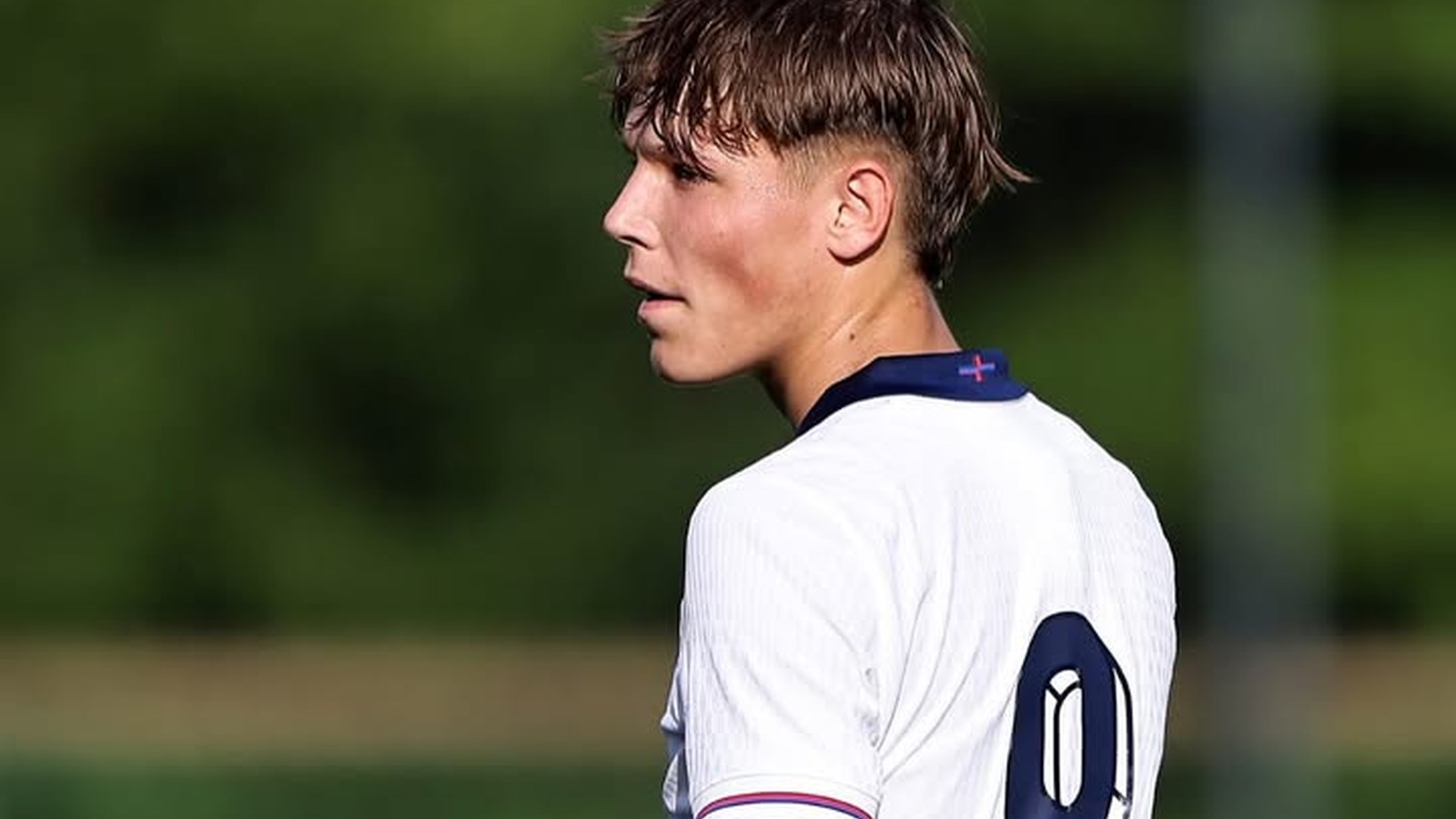 Young male footballer on pitch