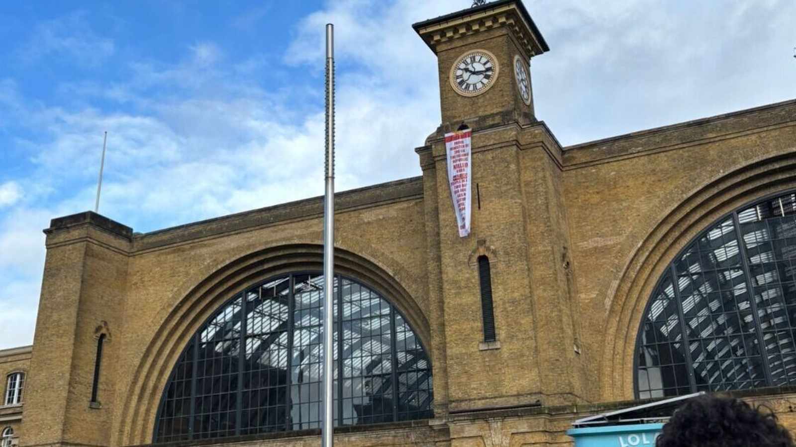 Protester on Kings Cross station building