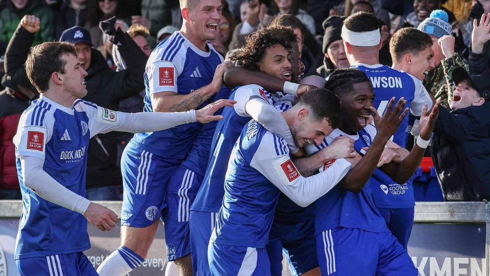 Macclesfield football players celebrating on field