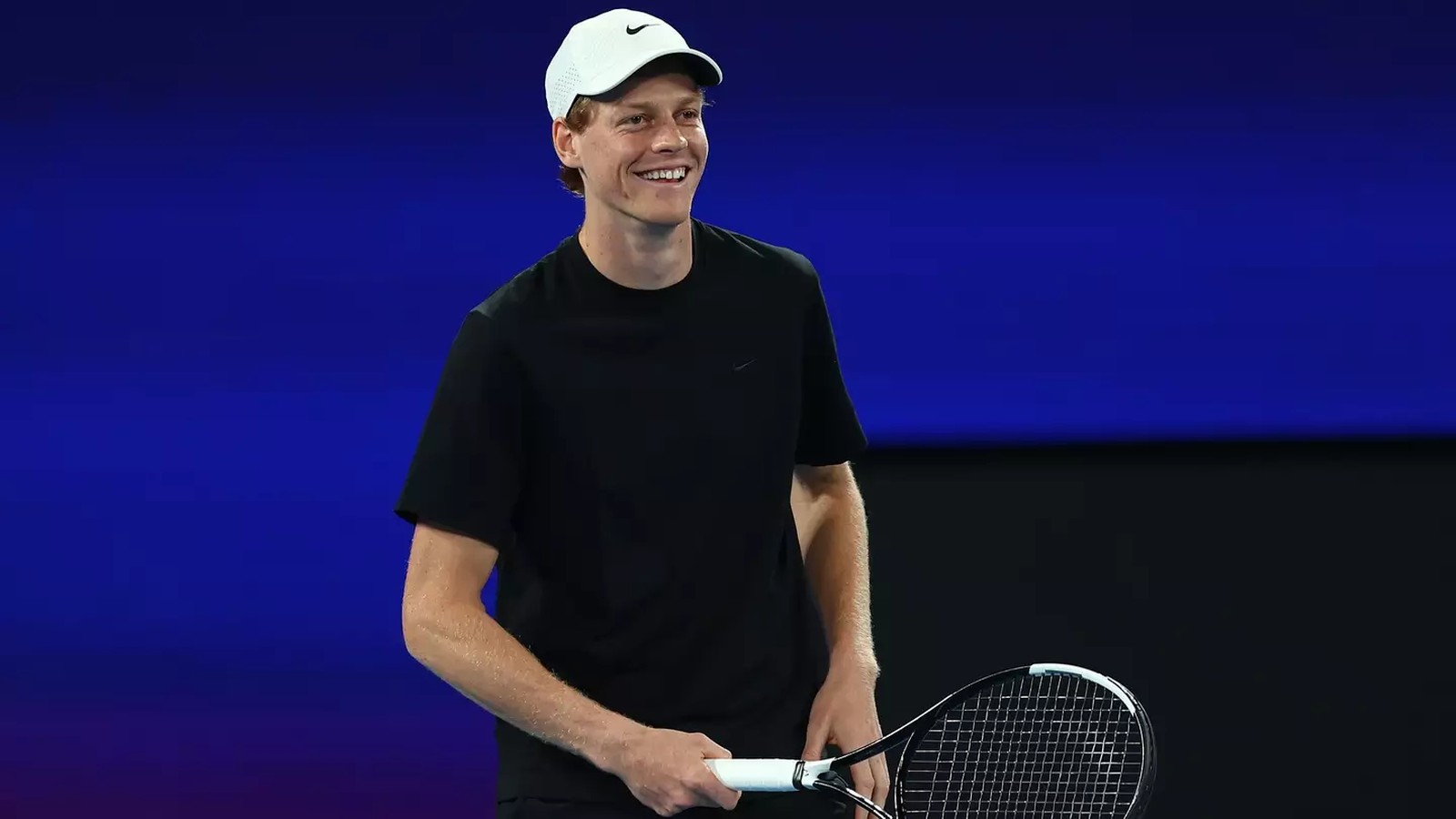 Tennis player serving on court