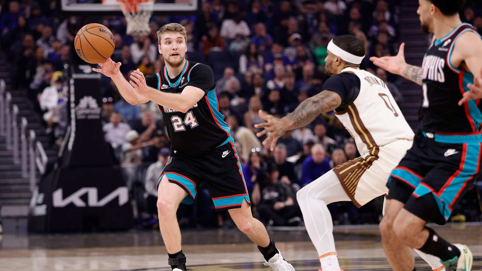 Two basketball players contesting a ball