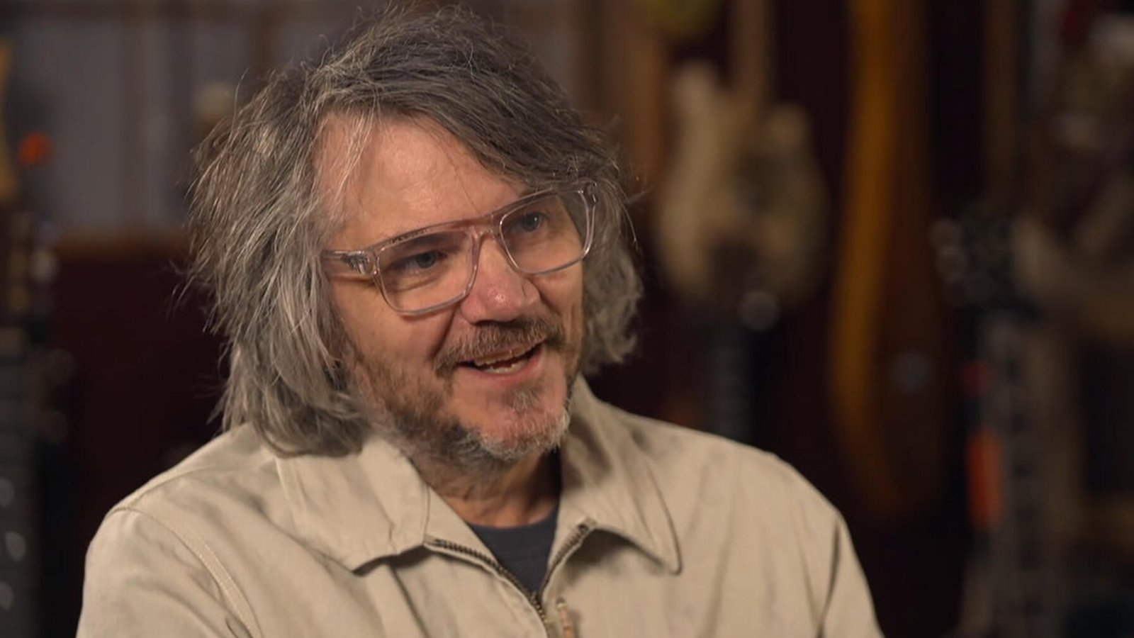Jeff Tweedy playing acoustic guitar