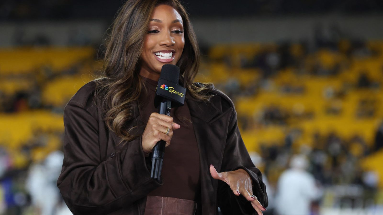 Maria Taylor holding a microphone
