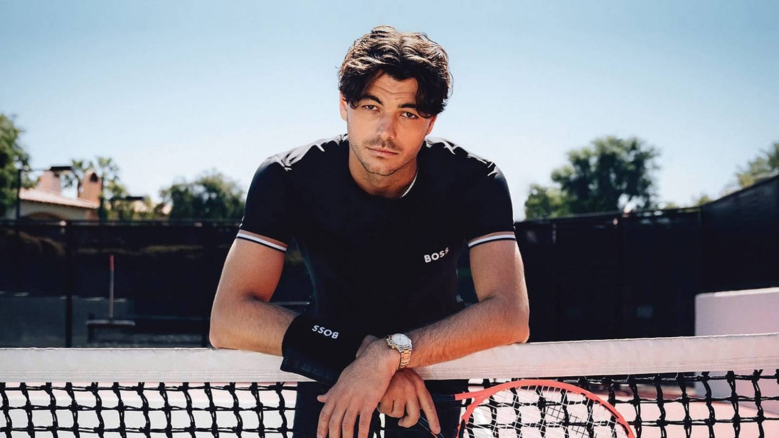 Taylor Fritz serving during a tennis match