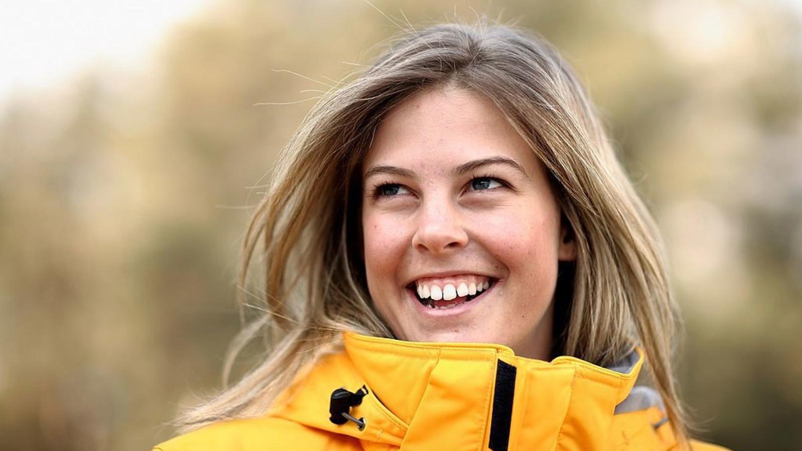 Torah Bright smiling with snowboard