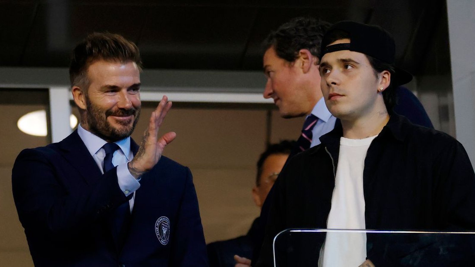 Brooklyn Beckham with David and Victoria Beckham