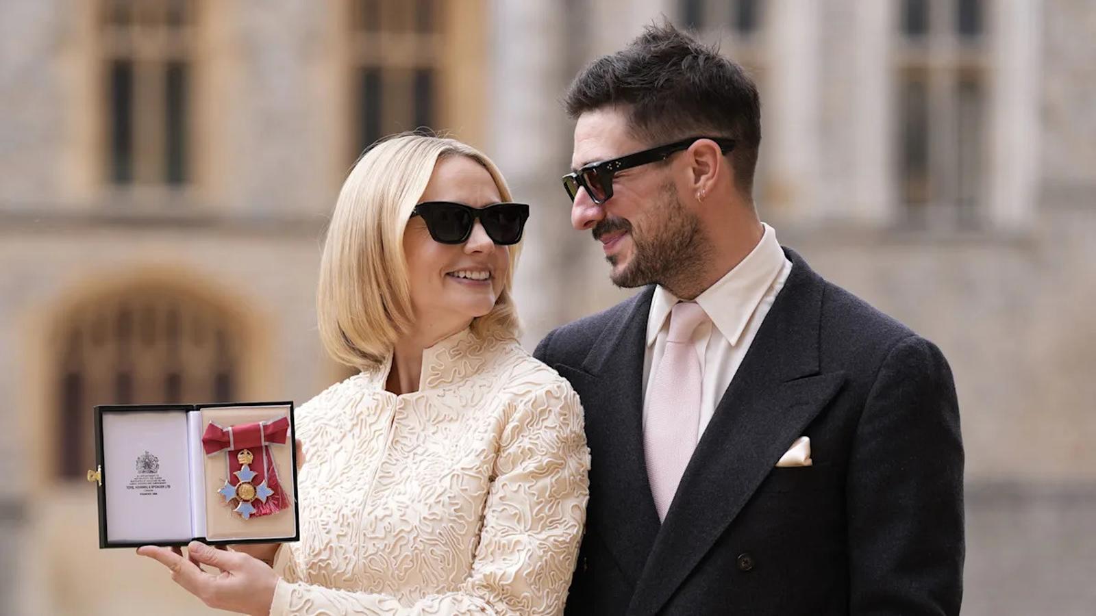 Carey Mulligan holding CBE insignia