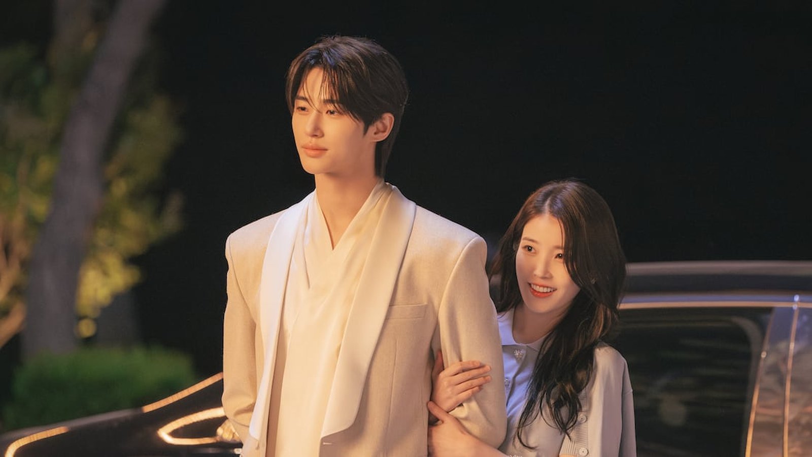 Byeon Woo-seok and IU standing together in a scene from Perfect Crown
