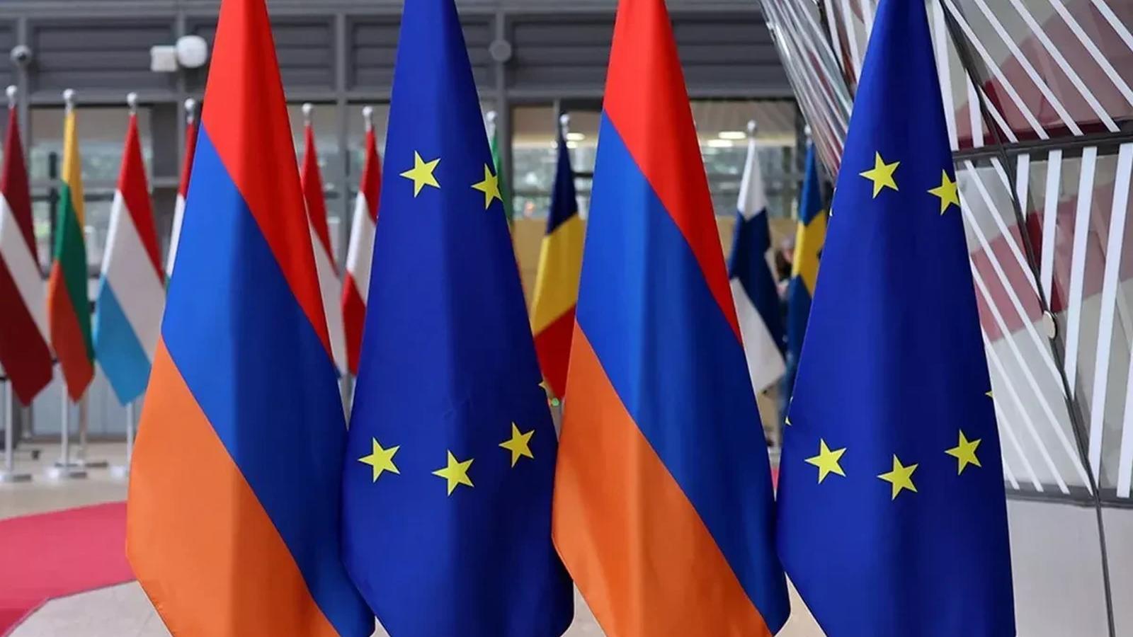 Flags of Armenia and the European Union displayed together in a formal setting