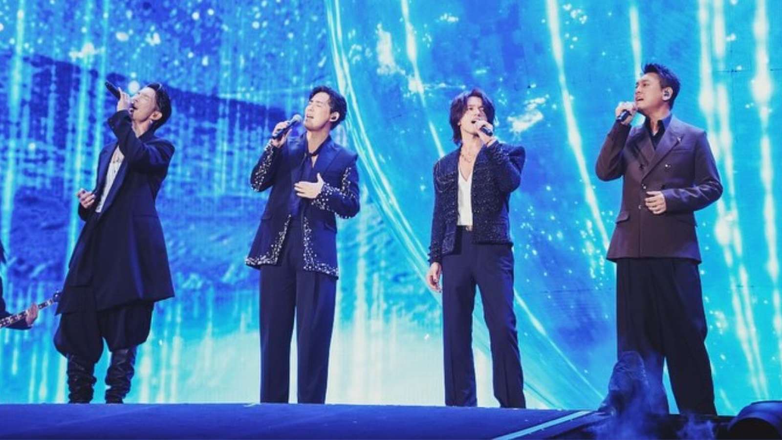 F4 band members performing on stage