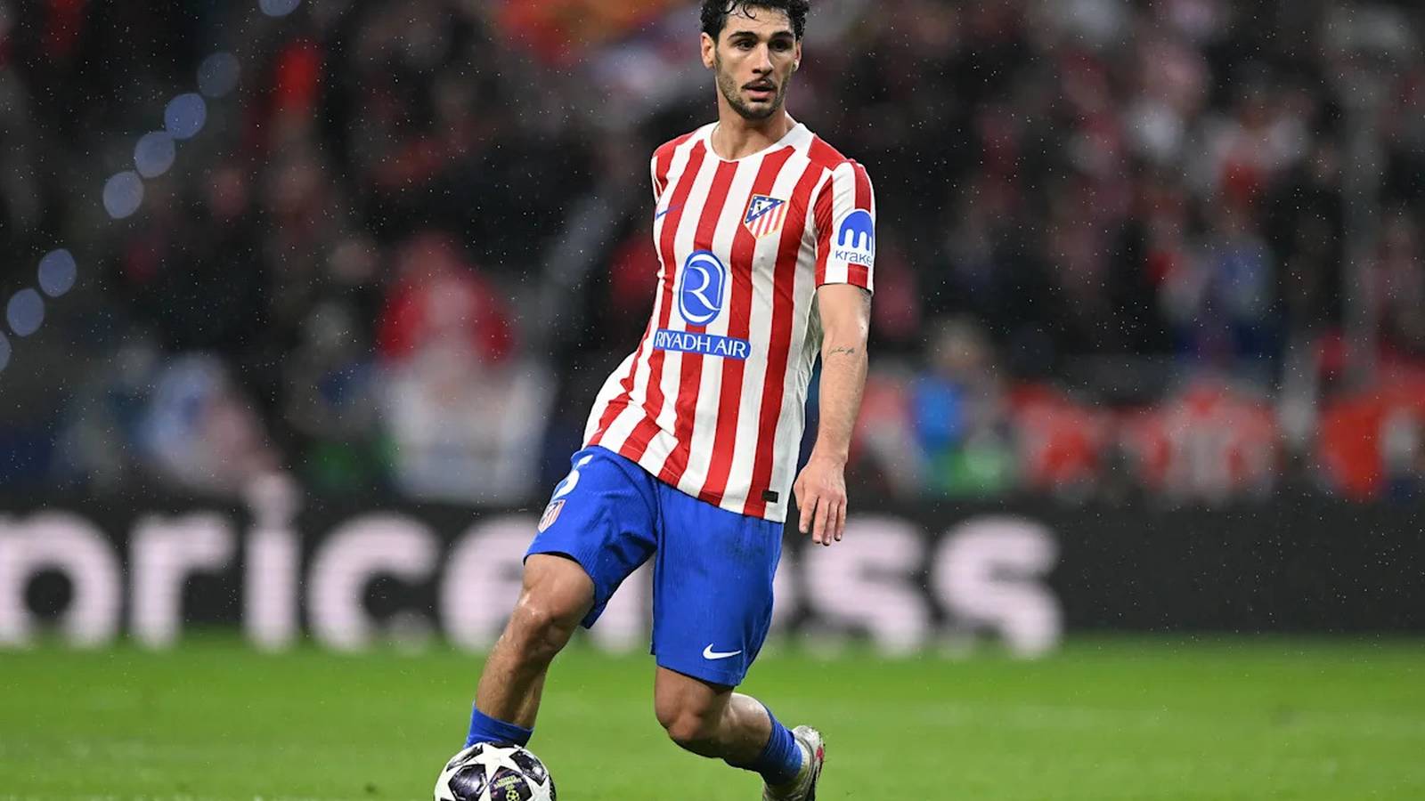 Johnny Cardoso dribbles a soccer ball during a professional Champions League match