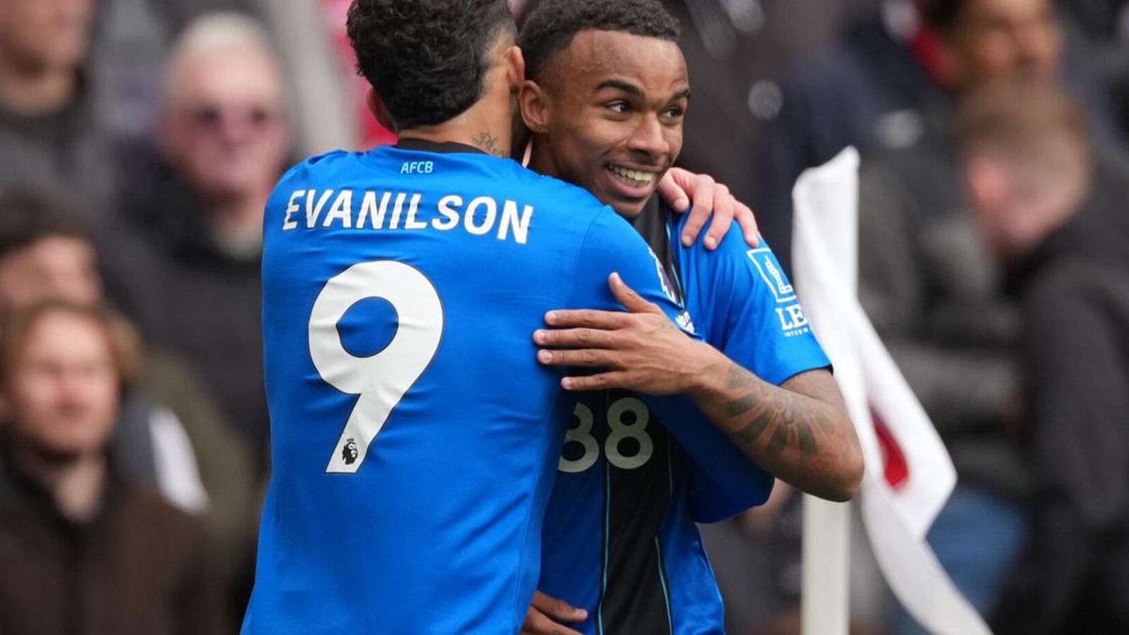 Bournemouth players Junior Kroupi and Evanilson embrace while celebrating a goal on pitch