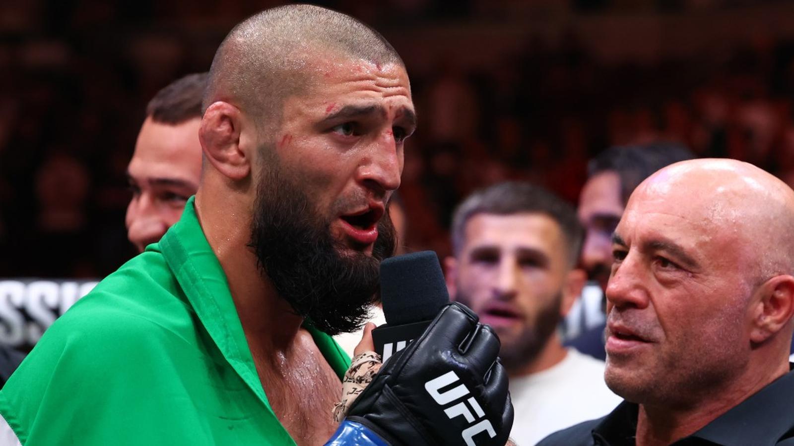Khamzat Chimaev speaking into a microphone during a post fight UFC interview