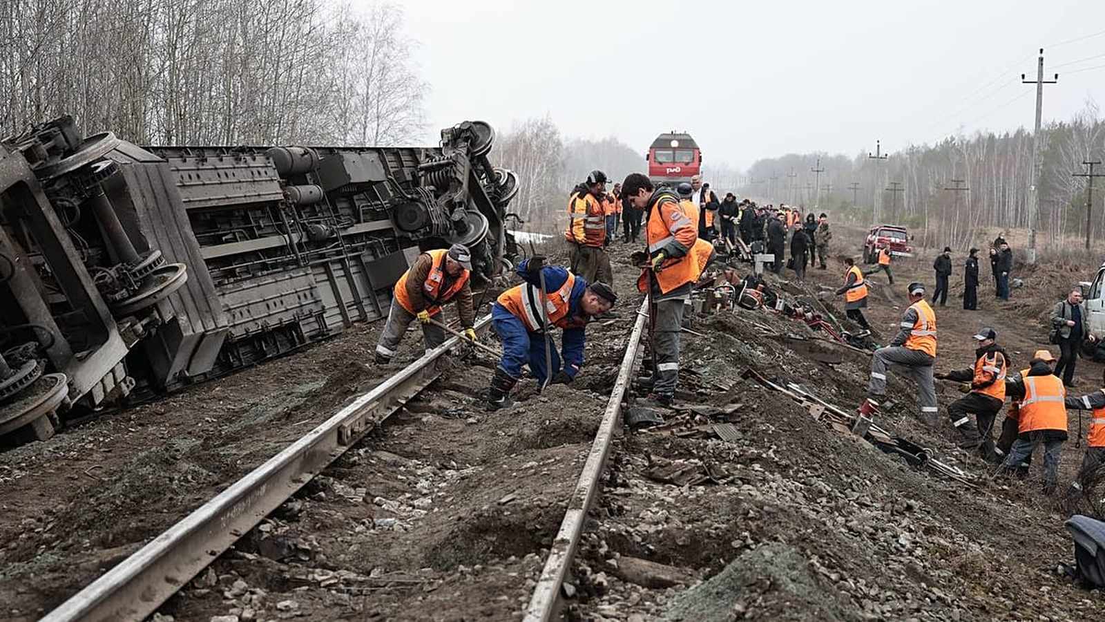 Damaged train carriages lying on their side