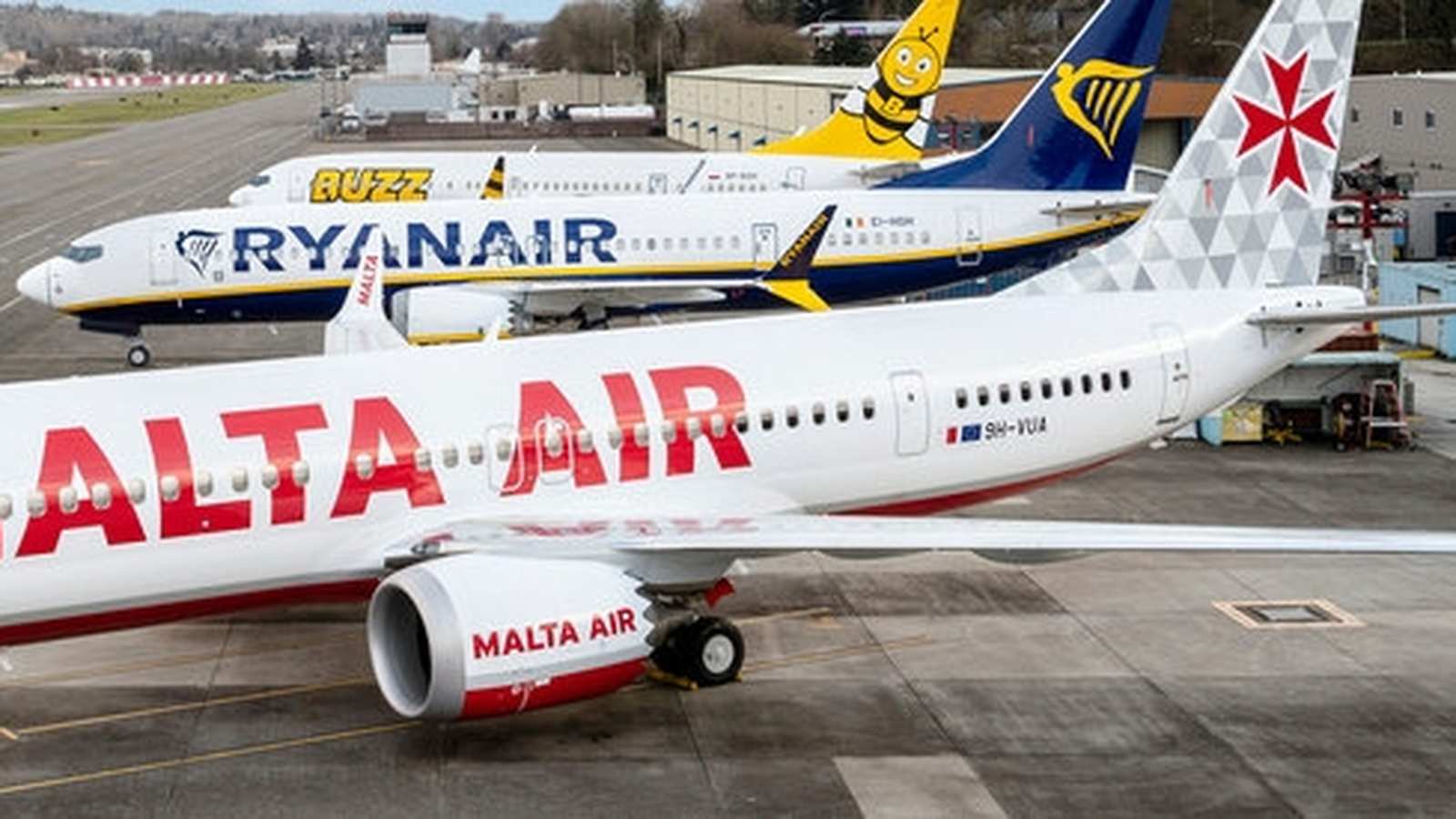 A Malta Air passenger jet parked on the tarmac with Ryanair planes behind