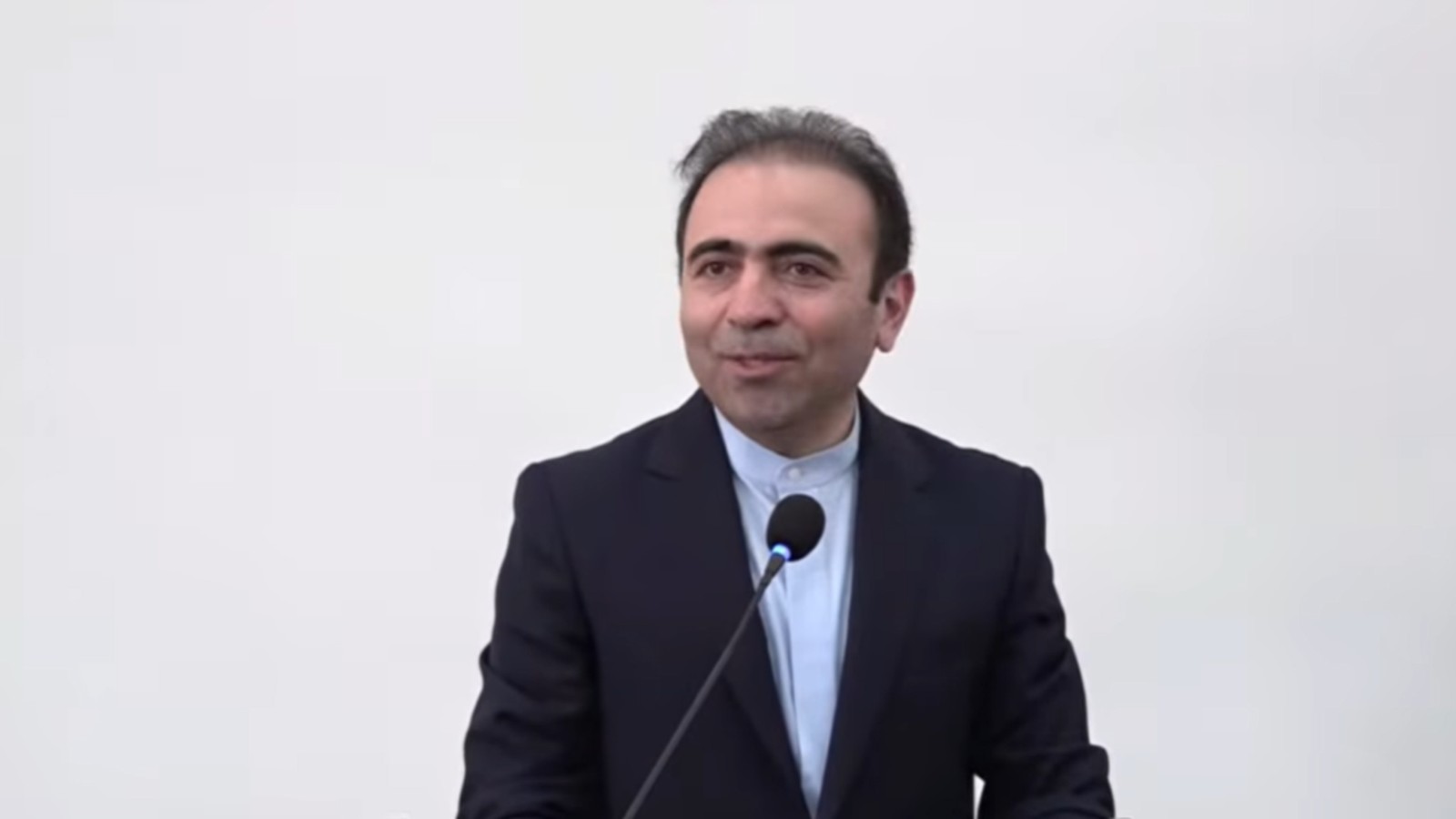 Political analyst Suren Sargsyan speaking at a podium during a press conference