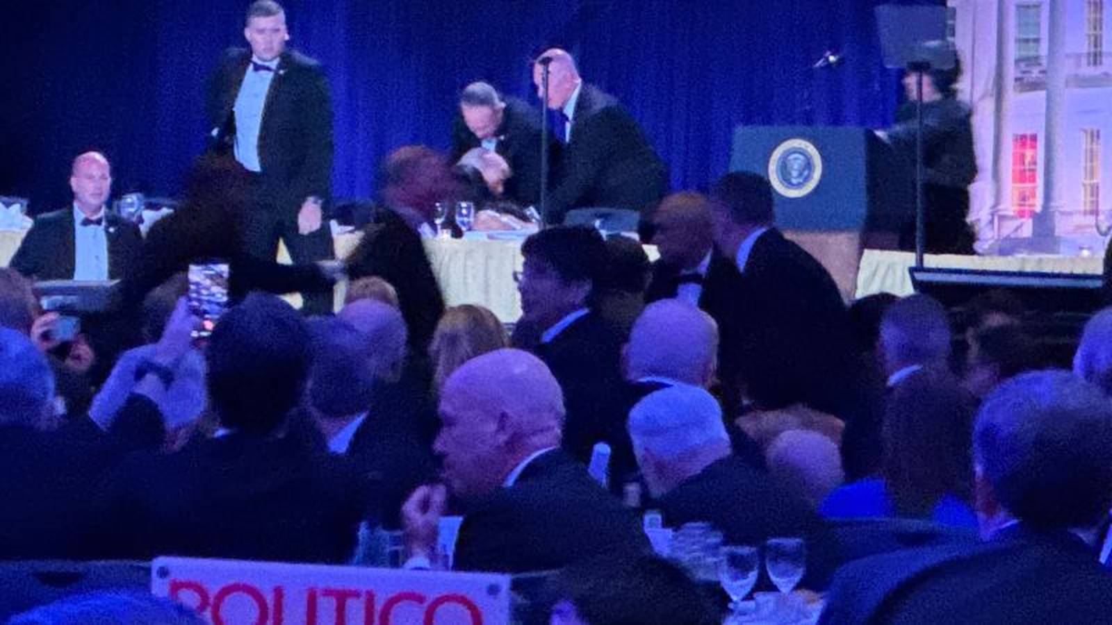 Security personnel responding to a disturbance at the White House Correspondents Association dinner