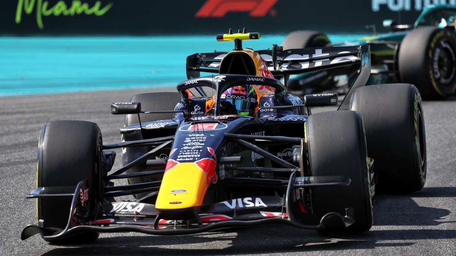 A Formula 1 race car driving on the Miami International Autodrome track surface.