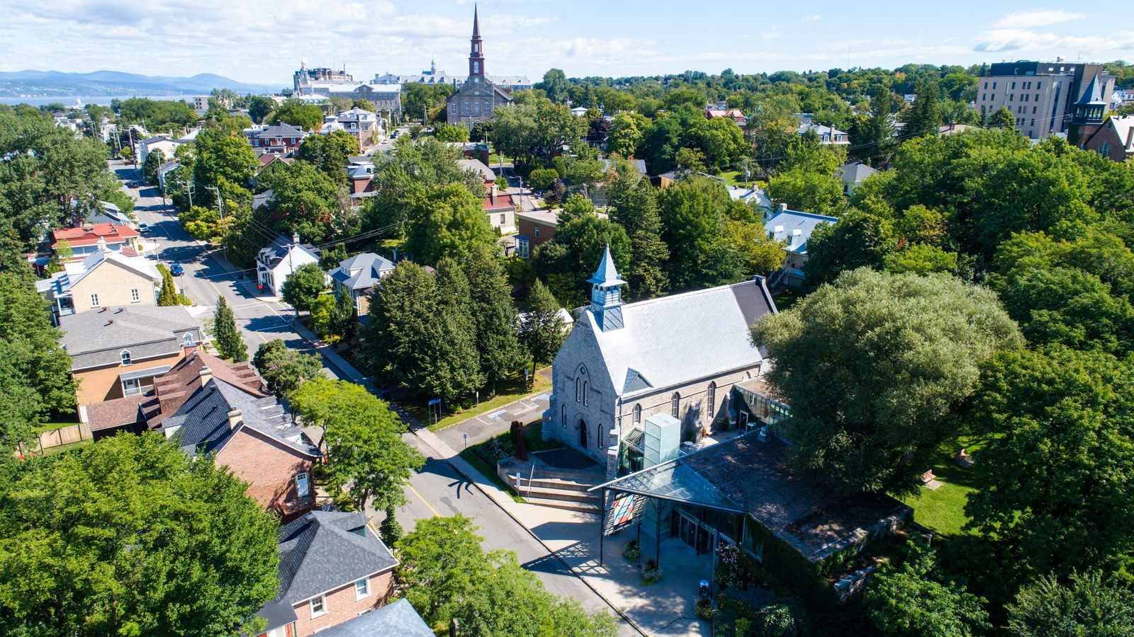 An aerial view of the historic district in Lévis Quebec featuring stone churches