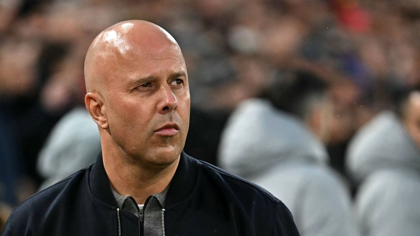 Liverpool head coach Arne Slot looking focused on the sidelines during a match