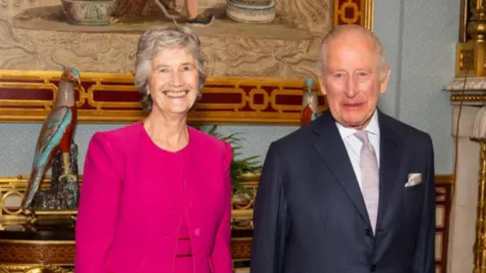 Catherine Connolly in a pink jacket standing beside King Charles III indoors