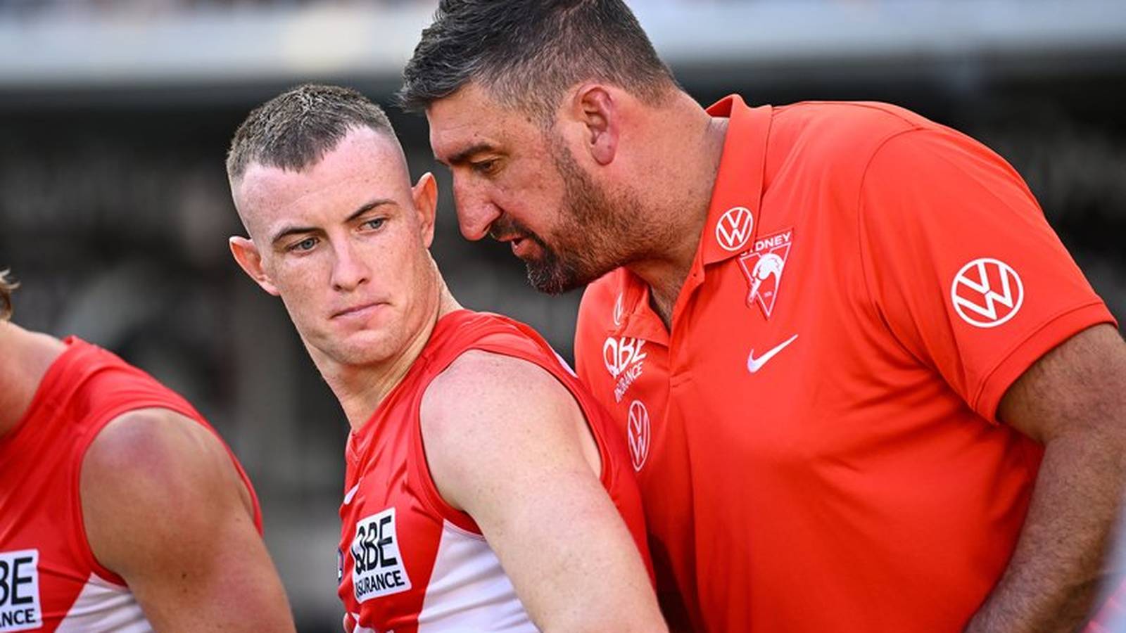 Sydney Swans player Chad Warner listening to coach Dean Cox on the field