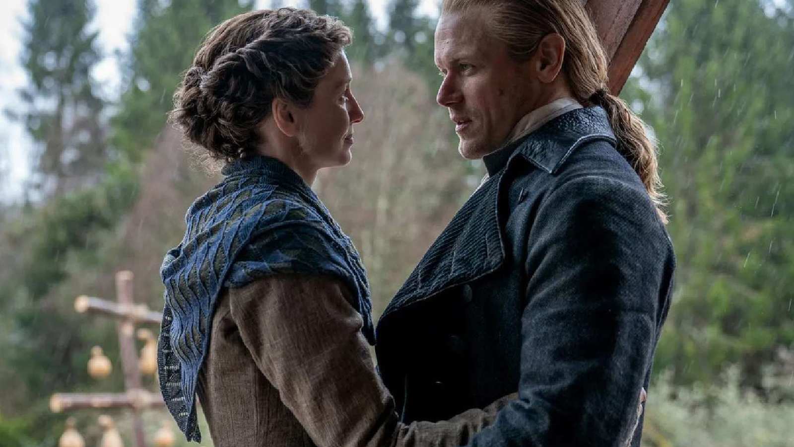 Claire and Jamie Fraser looking at each other in a romantic outdoor scene