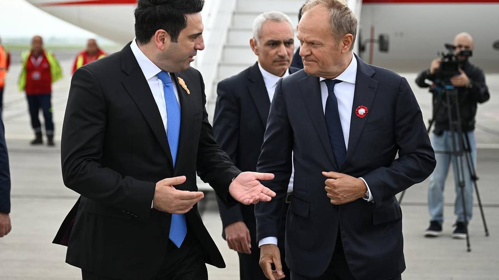 Polish Prime Minister Donald Tusk is greeted by Alen Simonyan at Zvartnots International Airport