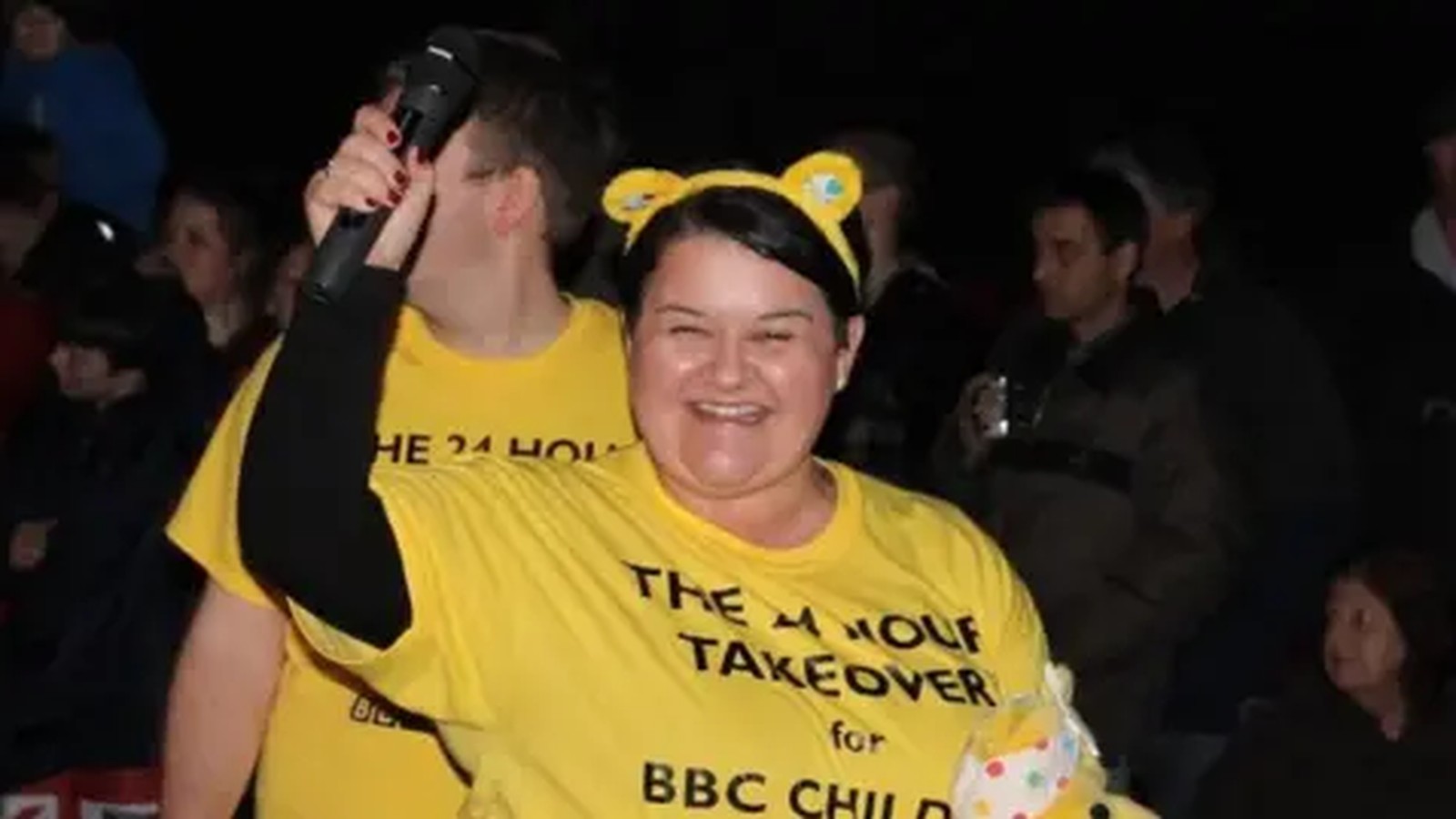 Emma Britton smiling while holding a microphone at a BBC charity event