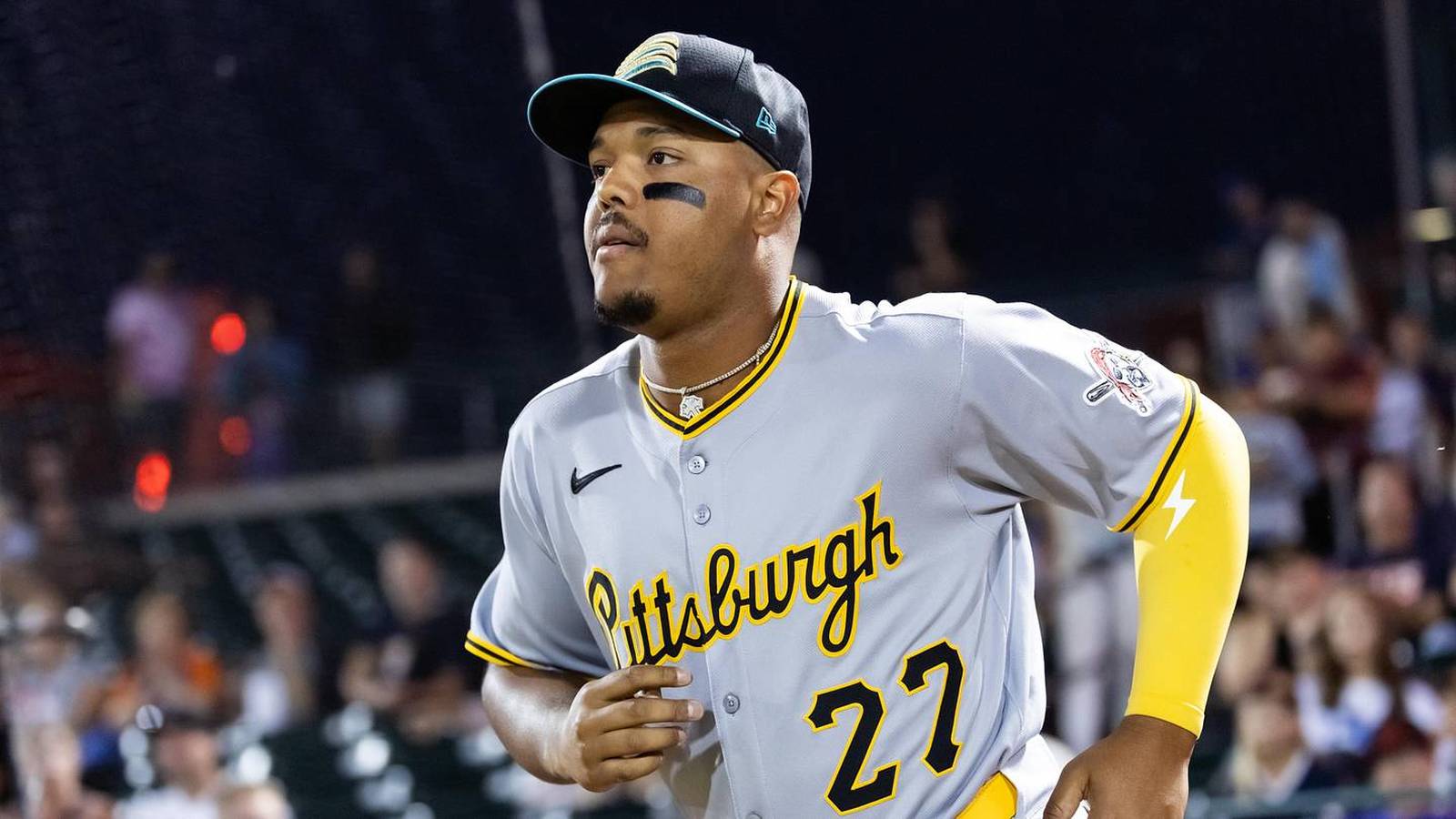 Pittsburgh Pirates player Esmerlyn Valdez wearing a grey jersey and black cap on field