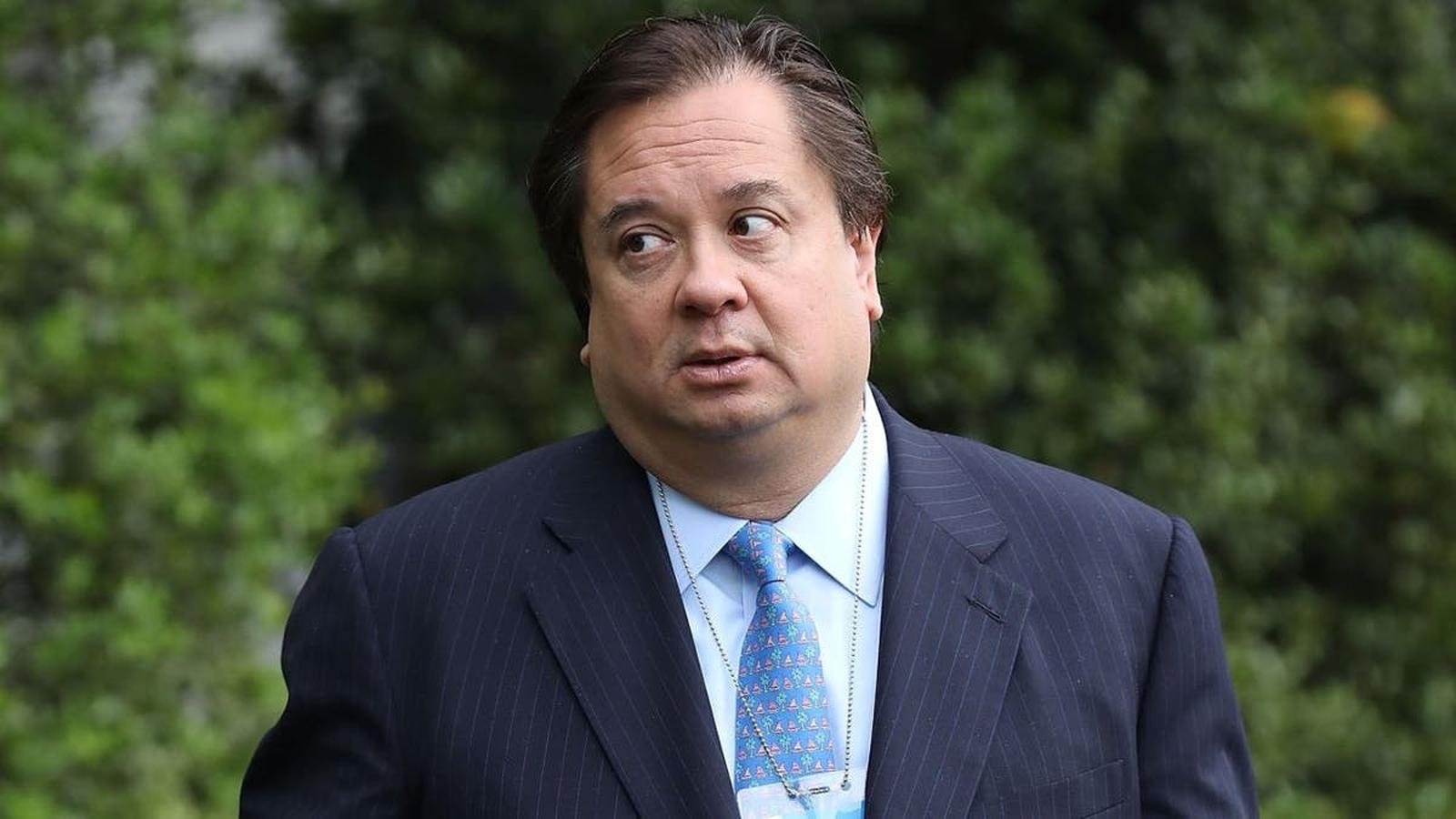 George Conway wearing a dark suit and blue patterned tie outdoors