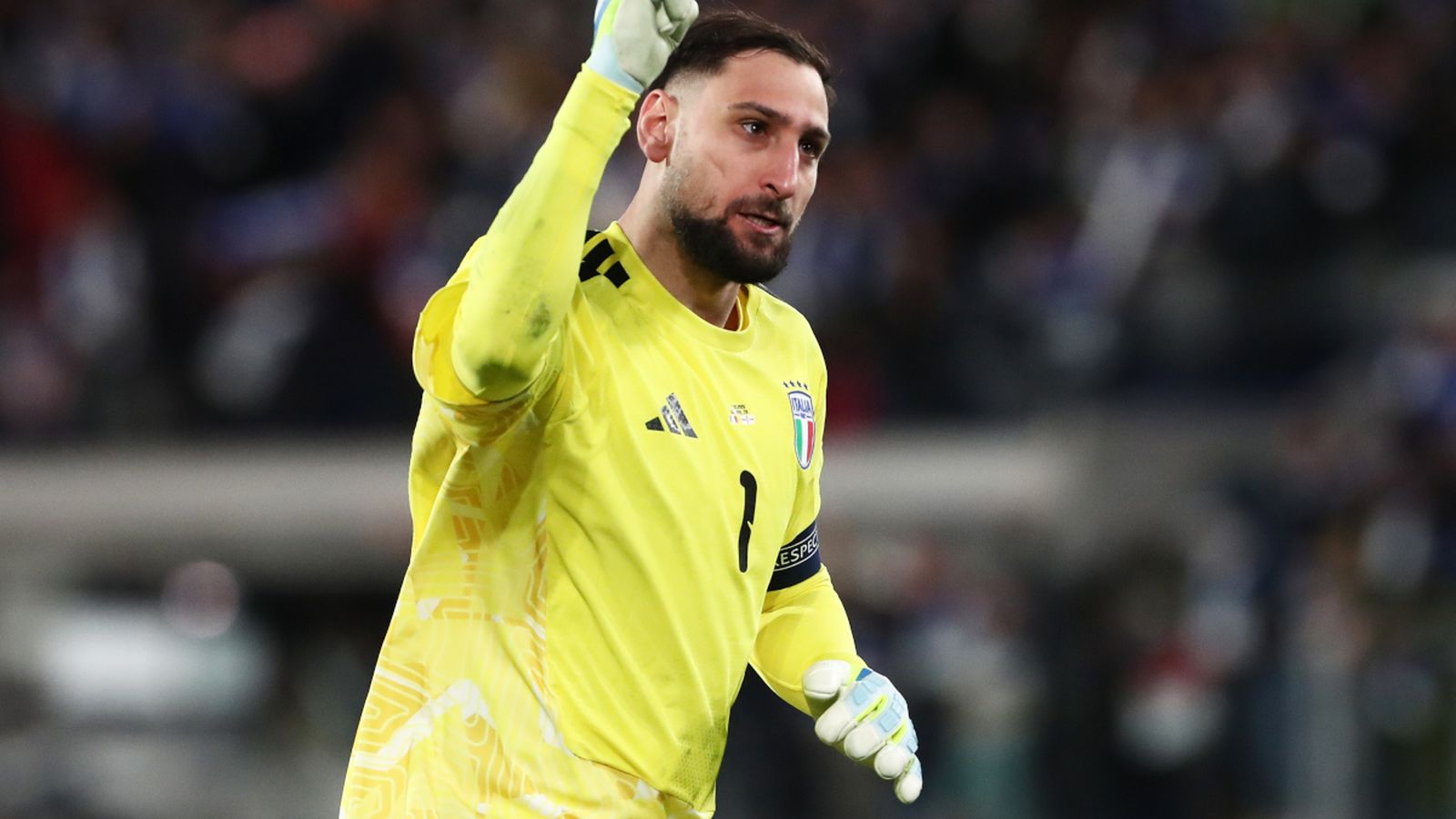 Gianluigi Donnarumma celebrating in his bright yellow Italy national team goalkeeper jersey