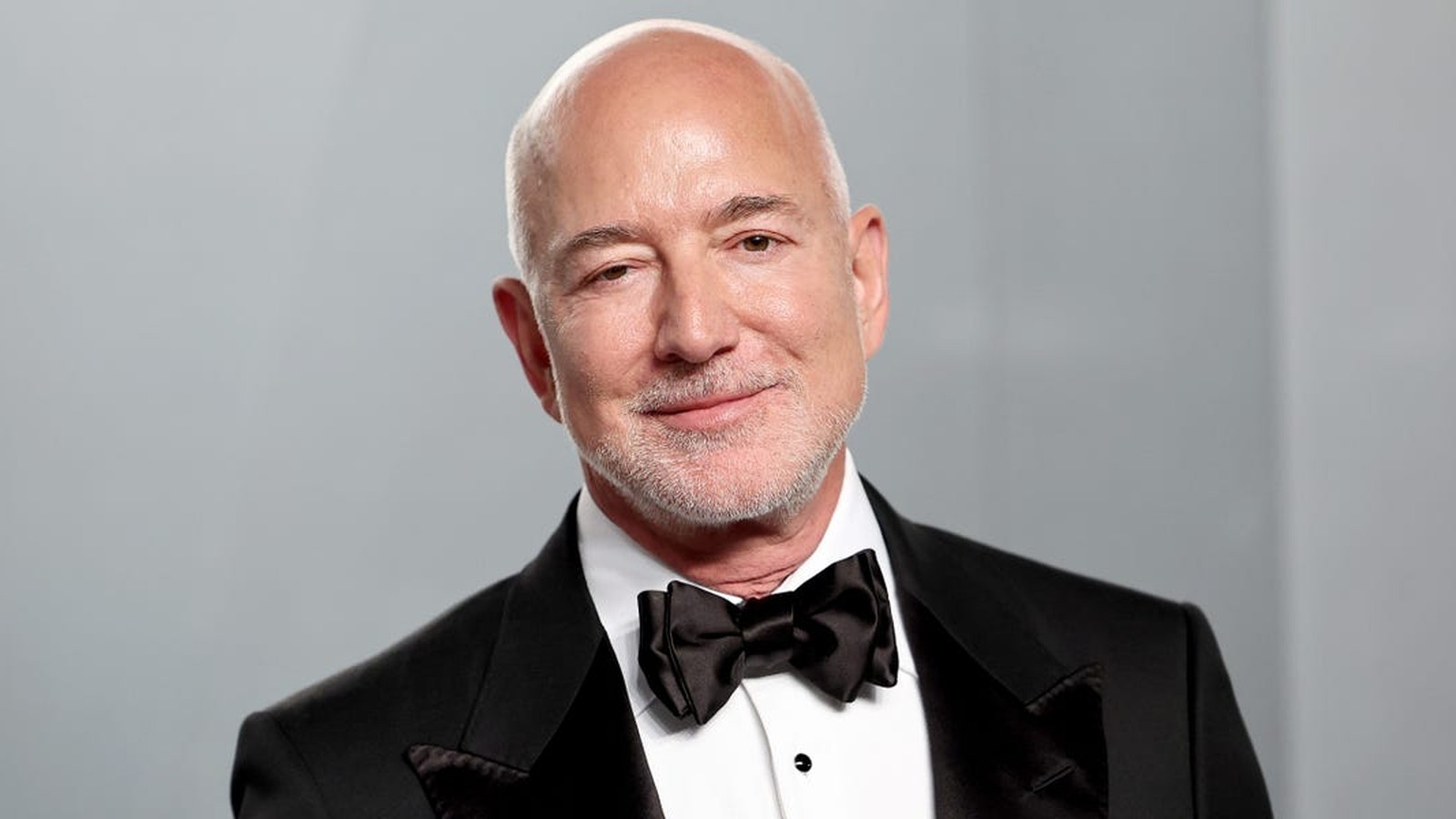 Jeff Bezos wearing a black tuxedo and bow tie looking at the camera