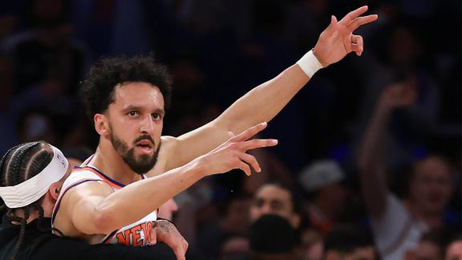 Landry Shamet in a New York Knicks jersey gesturing during a basketball game