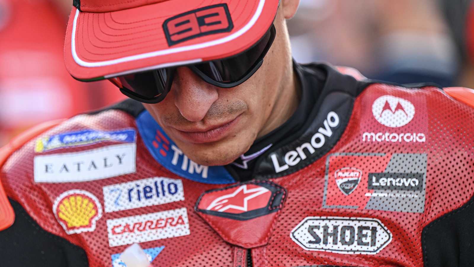 Close-up of Marc Marquez wearing a red cap with number 93 and racing leathers
