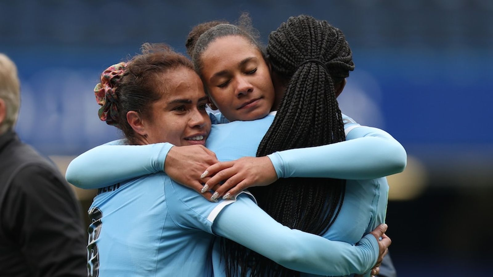 Mary Fowler and Manchester City teammates embracing on the pitch after a match