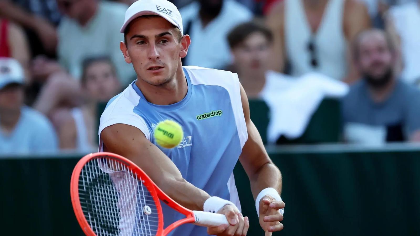 Italian tennis player Matteo Arnaldi hitting a forehand shot during a match