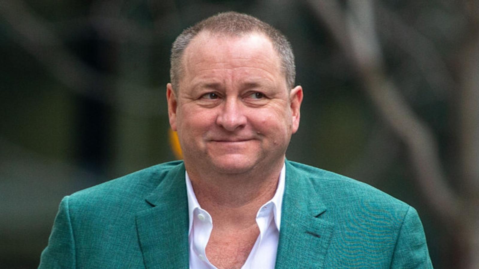 Retail mogul Mike Ashley wearing a green blazer and white shirt looking sideways