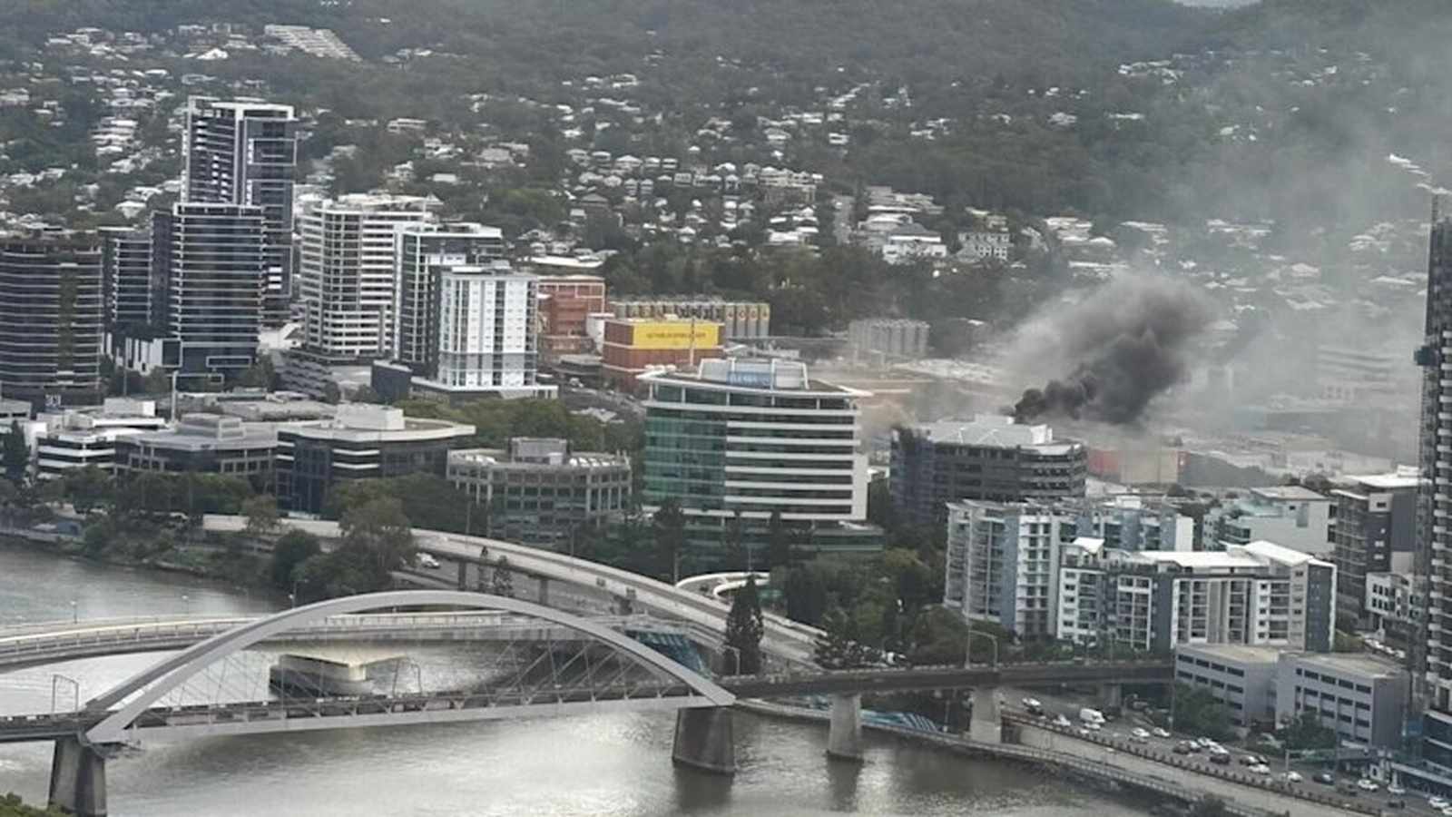 Thick black smoke rising from a multi-storey building in the Milton urban area
