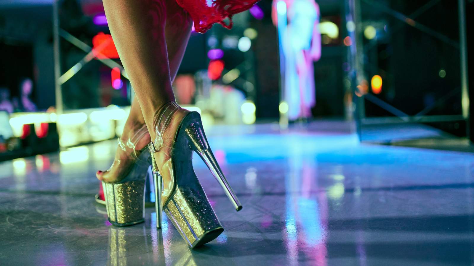 Close up of a dancer wearing high platform heels on a nightclub stage