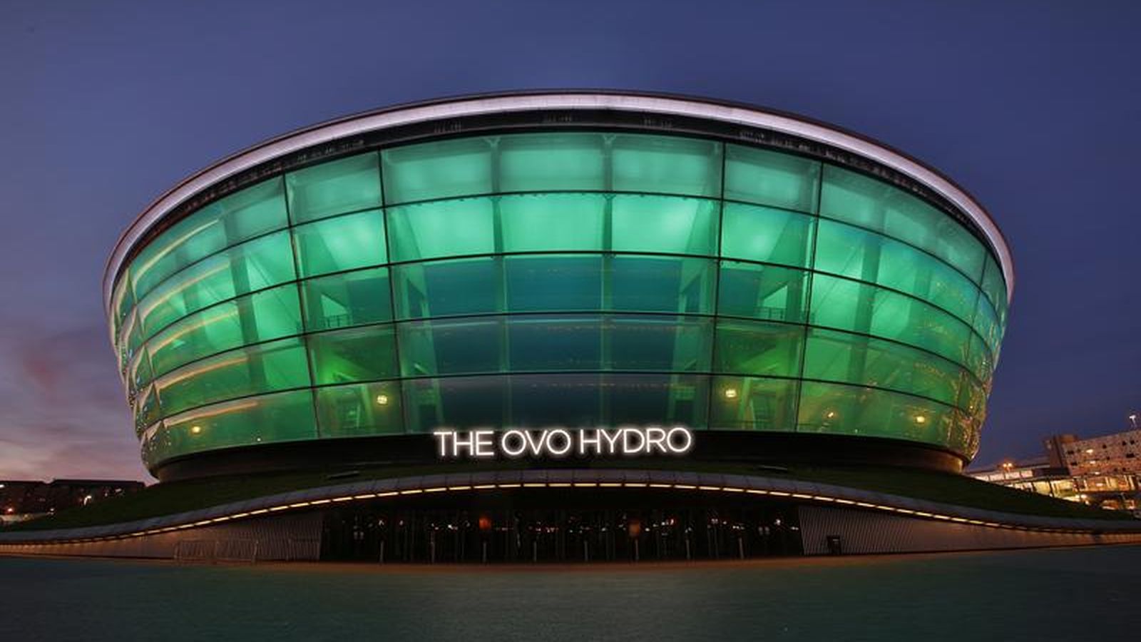 The illuminated OVO Hydro arena building in Glasgow at dusk with green lighting