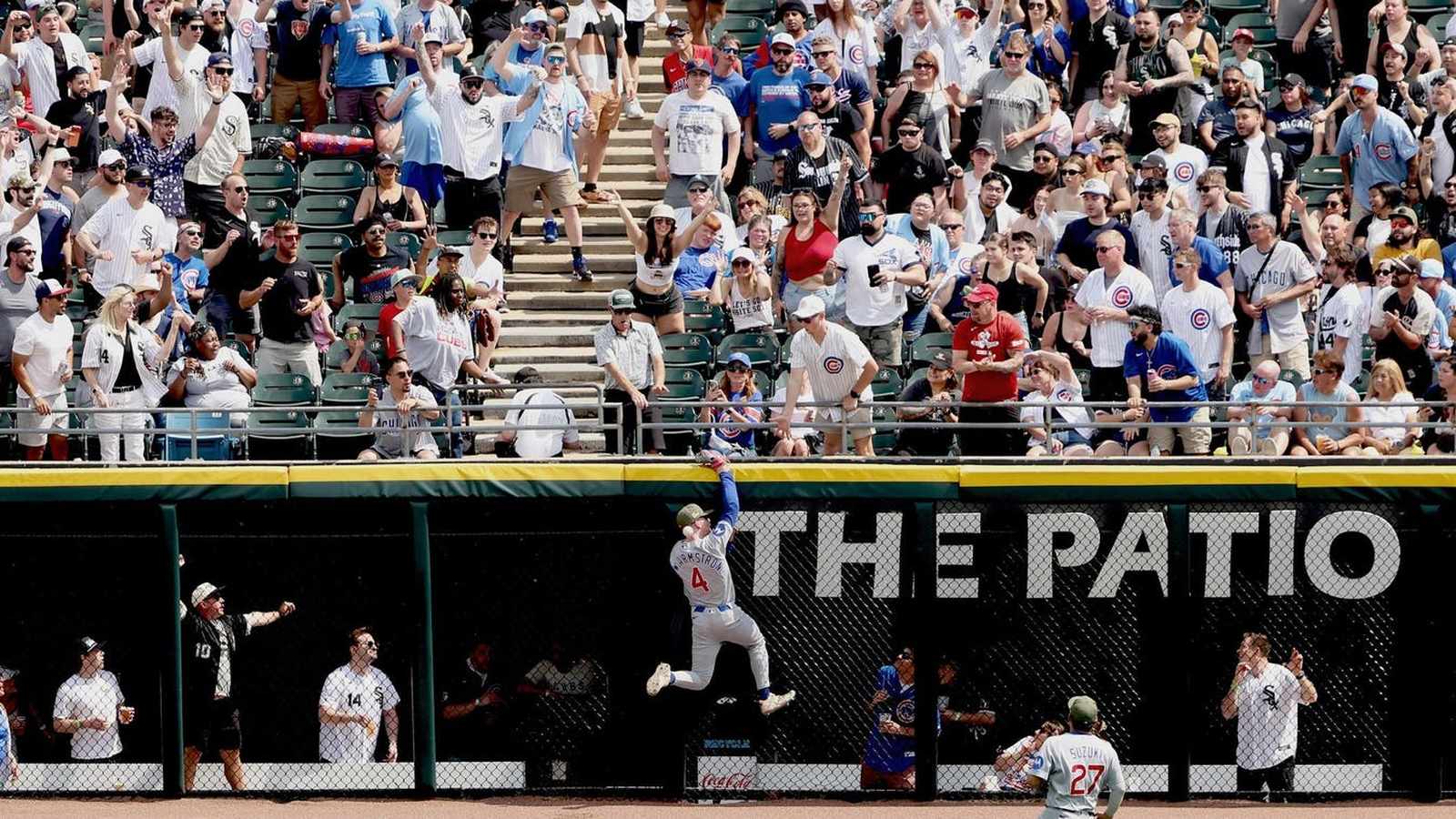 Chicago Cubs outfielder Pete Crow-Armstrong leaping to catch a ball at the wall