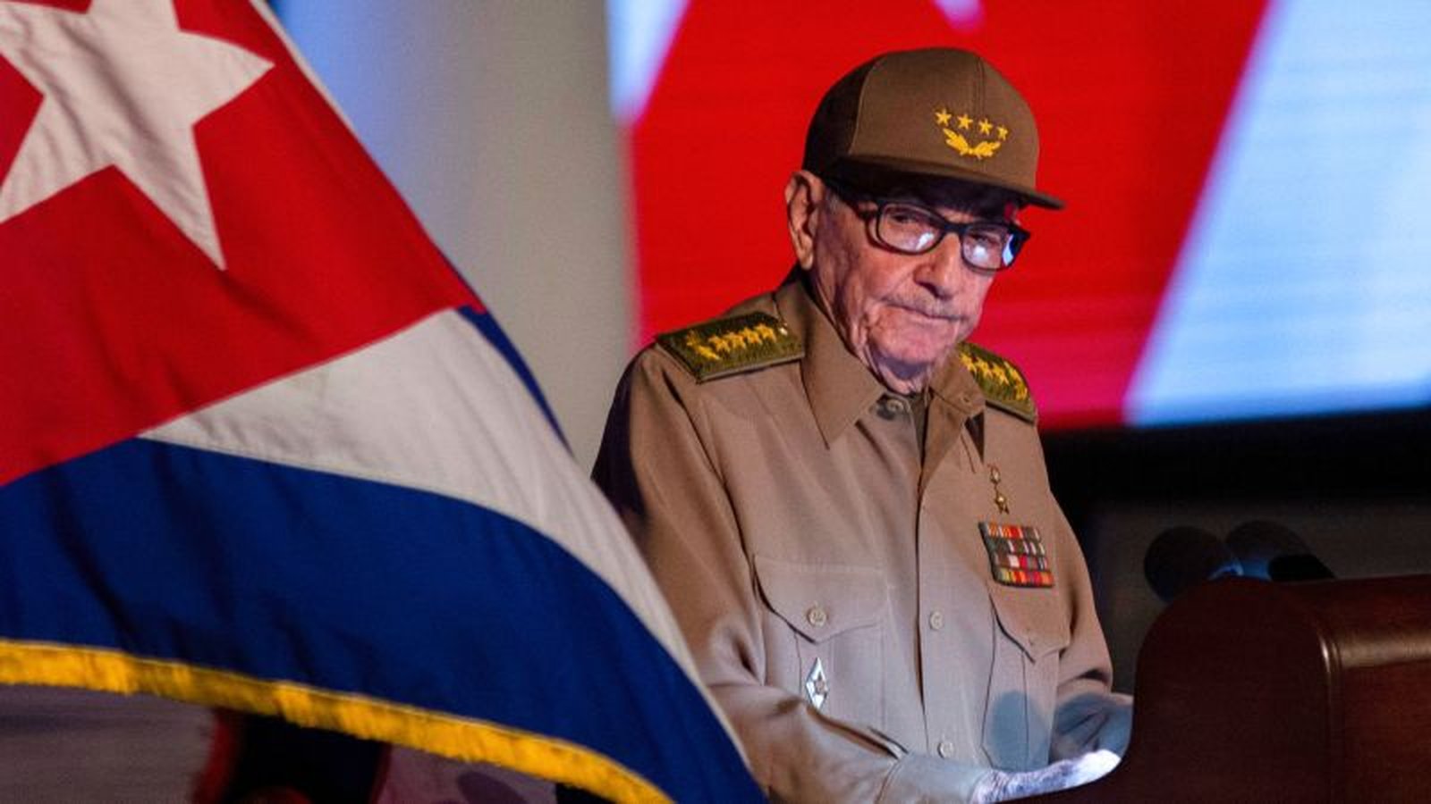 Former Cuban leader Raul Castro wearing a military uniform and cap at a podium