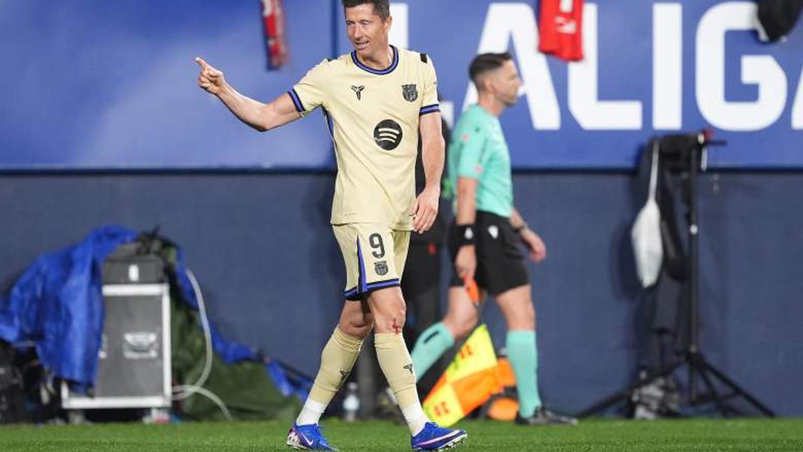 Robert Lewandowski wearing the Barcelona kit and pointing during a La Liga football match
