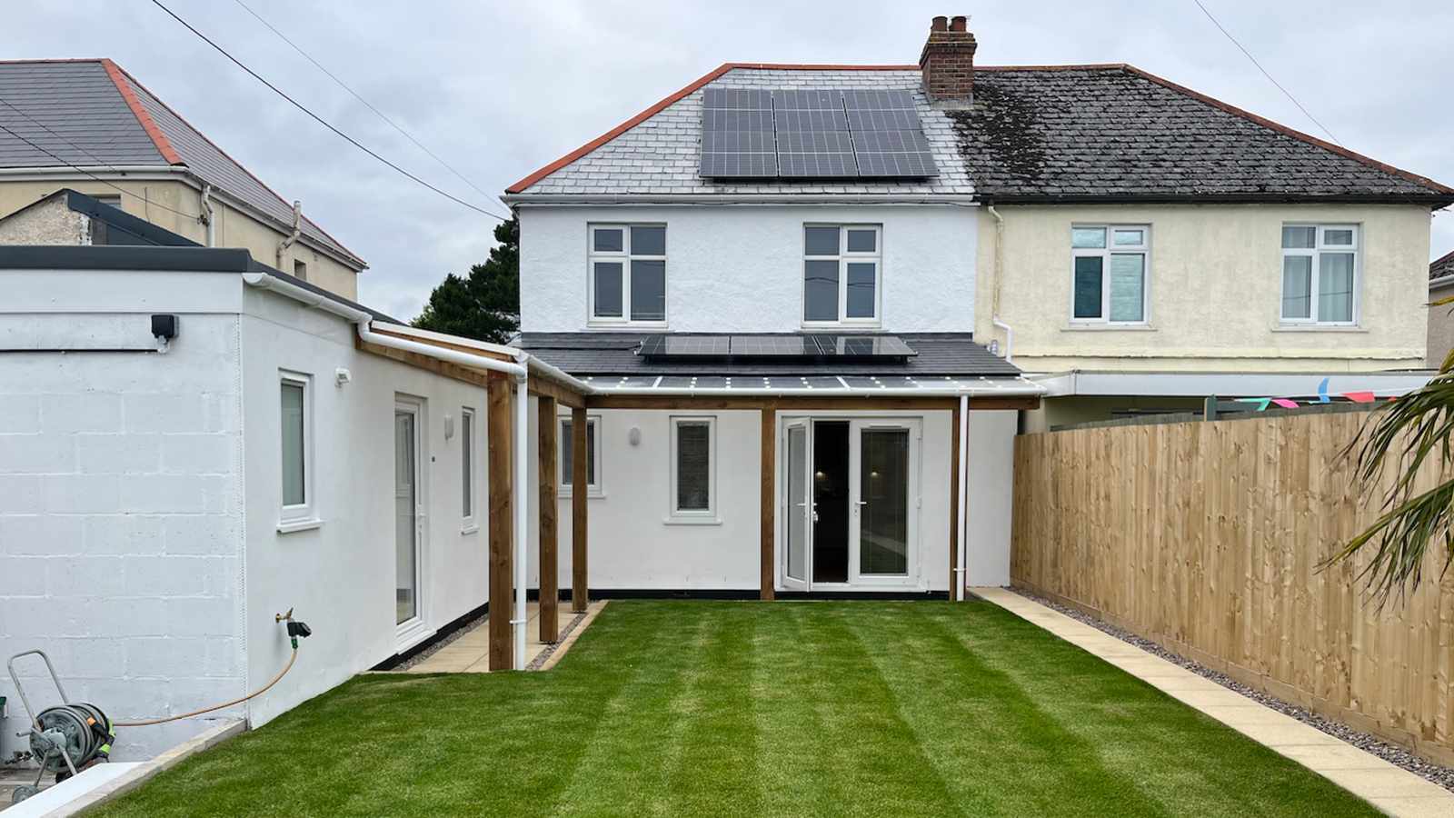 A modern eco-friendly house with solar panels and a garden in the Isles of Scilly
