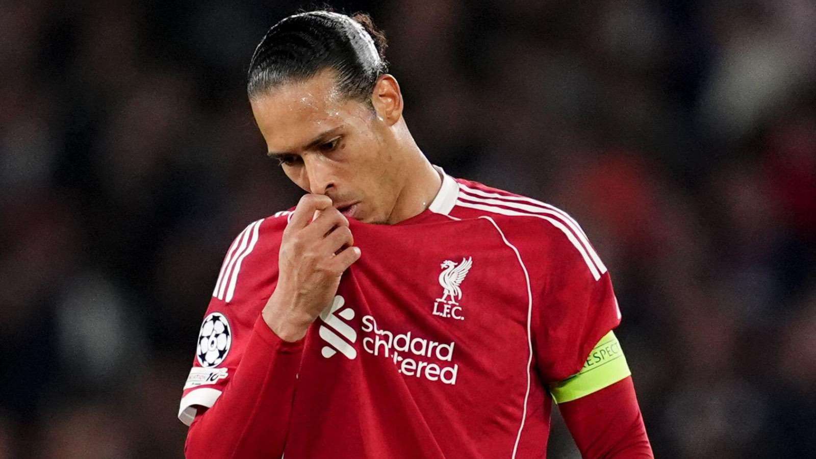 Virgil van Dijk, captain of Liverpool FC, wearing his red jersey and looking down