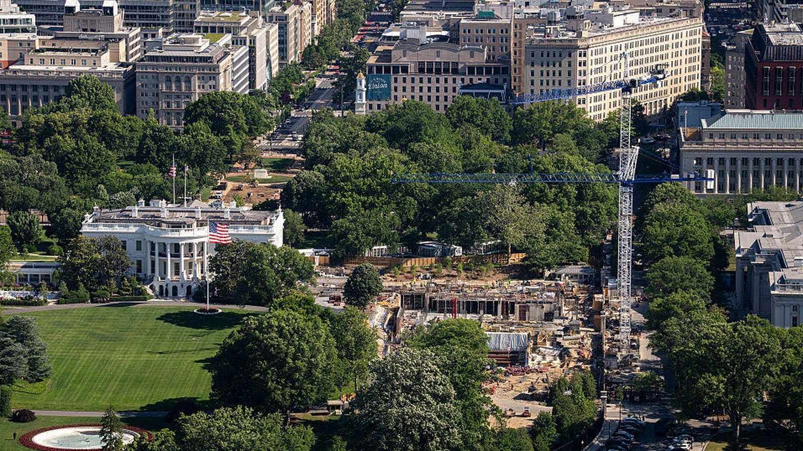 Aerial view of the White House grounds showing active construction and a large crane