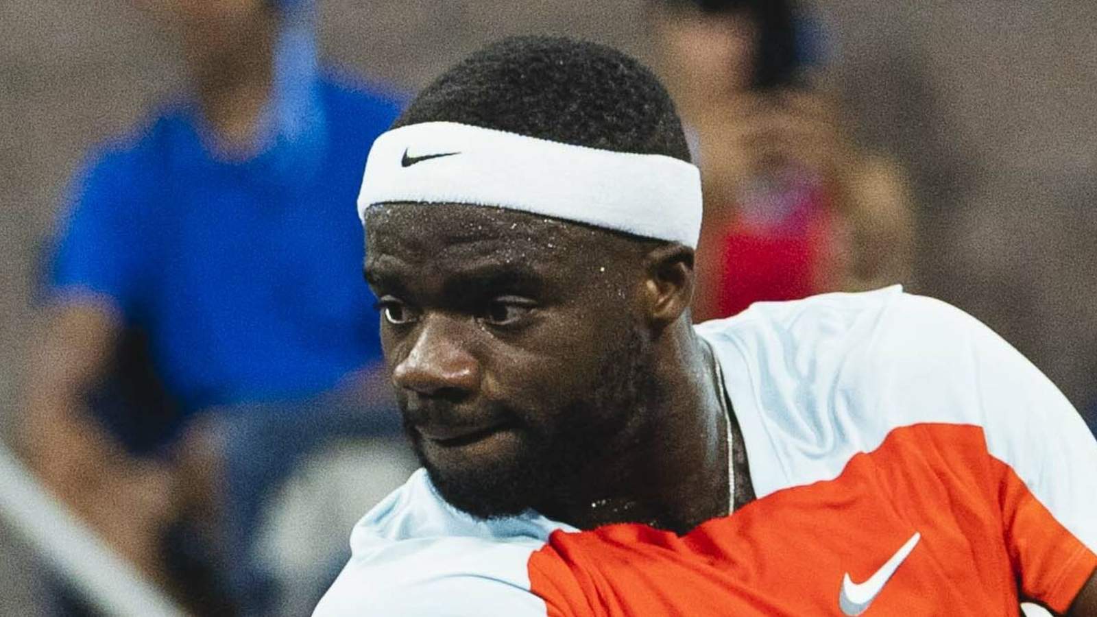 Frances Tiafoe returns to the US Open with hopes of another deep run, facing challenges on and off the court, including his back injury and the chaos of Flushing Meadows.