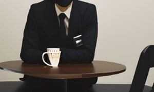 Dark Suit Sitting In A Cafe